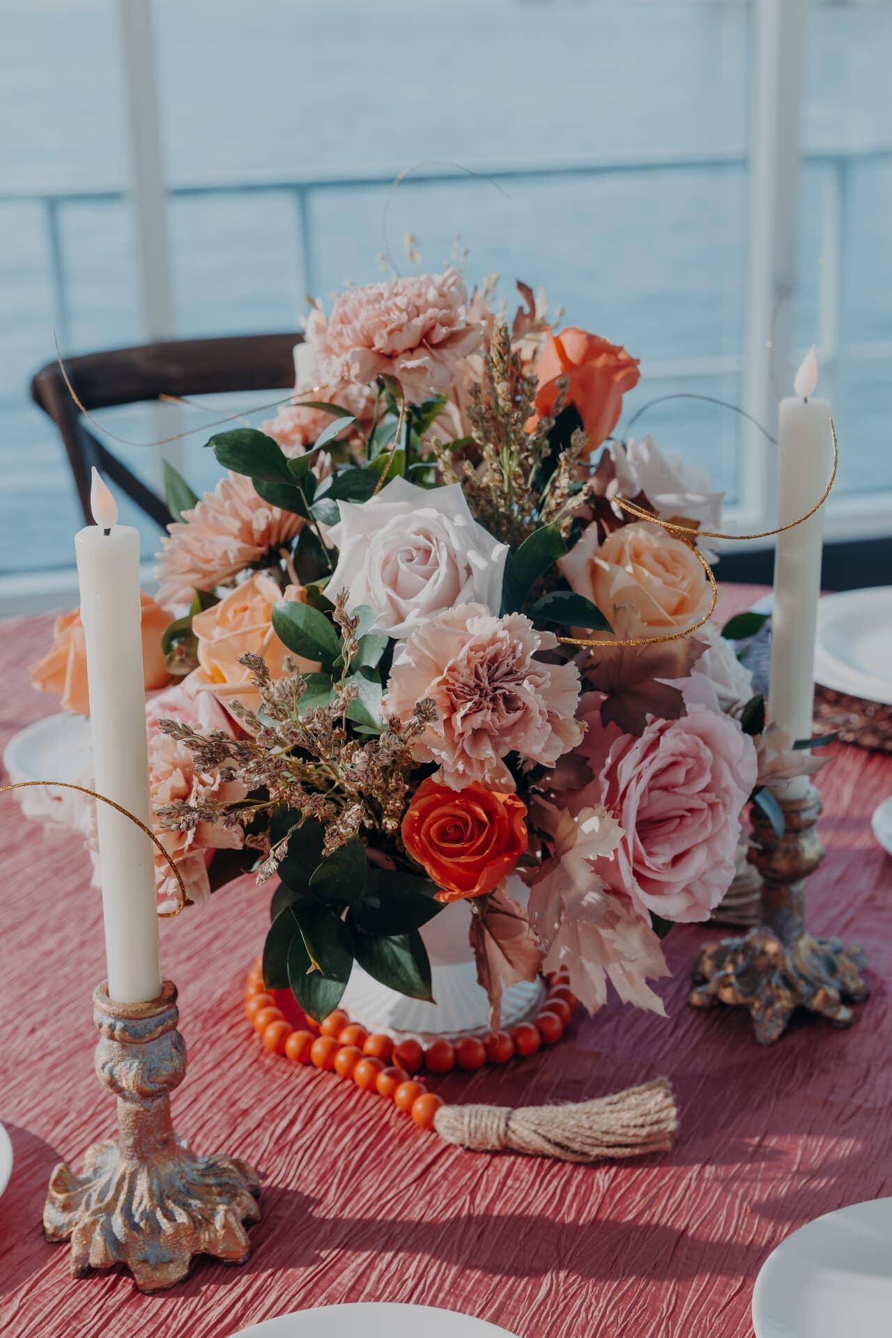 Peach and rose floral centerpiece planned by Kingsley Event Consulting