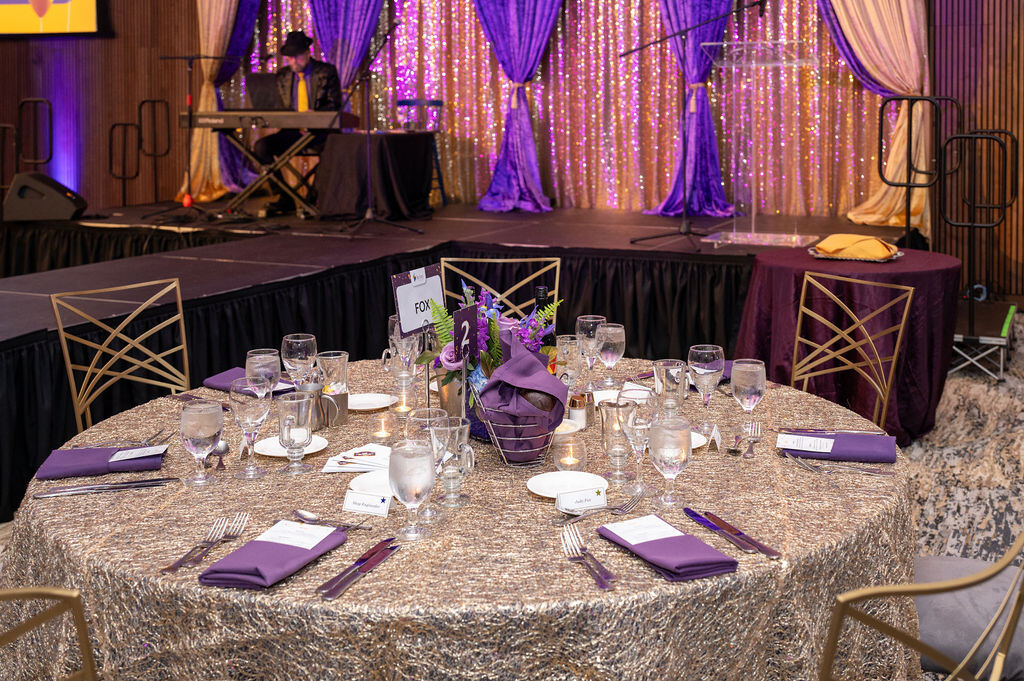 Gold and violet gala dinner planned by Kingsley Event Consulting